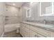 Modern bathroom featuring dual sinks, granite counters, soaking tub with shower, and wood-look flooring at 1600 W Ivar Rd, San Tan Valley, AZ 85144