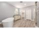 Bright bathroom features a soaking tub, vanity, and walk-in shower at 1600 W Ivar Rd, San Tan Valley, AZ 85144