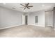 Spacious carpeted bedroom with neutral walls, a ceiling fan, and bright windows at 1600 W Ivar Rd, San Tan Valley, AZ 85144