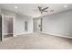 Spacious carpeted bedroom with neutral walls, a ceiling fan, and bright windows at 1600 W Ivar Rd, San Tan Valley, AZ 85144