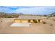 Exterior showcasing a three-car garage, desert landscaping, and scenic views at 1600 W Ivar Rd, San Tan Valley, AZ 85144