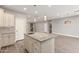 Bright kitchen features stainless steel appliances, granite countertops, and a stylish central island at 1600 W Ivar Rd, San Tan Valley, AZ 85144