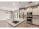 Bright kitchen features stainless steel appliances, granite countertops, and a stylish central island at 1600 W Ivar Rd, San Tan Valley, AZ 85144