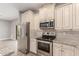 Bright kitchen features stainless steel appliances, granite countertops, and ample cabinet space at 1600 W Ivar Rd, San Tan Valley, AZ 85144