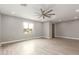Spacious living room featuring hardwood floors, ceiling fan, and large windows at 1600 W Ivar Rd, San Tan Valley, AZ 85144