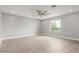 Bright living room showcasing hardwood floors, ceiling fan, and a cozy ambiance at 1600 W Ivar Rd, San Tan Valley, AZ 85144