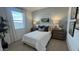 Cozy bedroom with a calming color scheme, a large window, and stylish decor at 17685 W Southgate Ave, Goodyear, AZ 85338