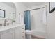 Modern bathroom featuring a sleek vanity, quartz countertop, round mirror and a shower-tub combo at 17940 N Luke Ln, Maricopa, AZ 85139