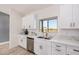 Bright kitchen with stainless steel appliances, white cabinetry, a window over the sink, and views of the desert at 17940 N Luke Ln, Maricopa, AZ 85139