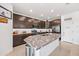 Modern kitchen with dark cabinets, granite countertops, and stainless steel appliances at 19856 W Monterosa St, Litchfield Park, AZ 85340