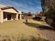 Large backyard with grass, stone features, patio and desert landscaping at 20865 E Shetland St, Queen Creek, AZ 85142