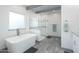 Modern bathroom featuring a freestanding tub, glass-enclosed shower, and stylish tile accents at 2106 W Shawnee Dr, Chandler, AZ 85224