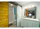 A charming bathroom offers a modern vanity with a sliding barn door to the shower and toilet at 2106 W Shawnee Dr, Chandler, AZ 85224