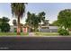 Charming single-story home with a beautifully landscaped front yard, mature trees, and inviting walkway at 2106 W Shawnee Dr, Chandler, AZ 85224