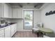 Bright kitchenette area with white cabinets, and a charming breakfast nook by the window at 2106 W Shawnee Dr, Chandler, AZ 85224