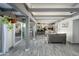Open-concept living area with beamed ceilings, tile floors, and seamless flow to the kitchen and outdoor space at 2106 W Shawnee Dr, Chandler, AZ 85224