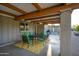 Inviting covered patio featuring a dining set with comfortable green cushions and a stylish yellow patterned rug at 2106 W Shawnee Dr, Chandler, AZ 85224
