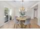 Elegant dining area featuring a round table with plush chairs and decorative chandelier at 2126 N 69Th Pl, Scottsdale, AZ 85257