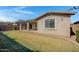 Beautiful backyard featuring a covered patio and a well-manicured lawn at 22443 E Munoz St, Queen Creek, AZ 85142