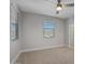 Well-lit bedroom with neutral carpet, a ceiling fan, and a view from the window at 22443 E Munoz St, Queen Creek, AZ 85142