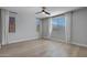 Spacious bedroom with wood floors, modern ceiling fan, and bright natural light at 22443 E Munoz St, Queen Creek, AZ 85142