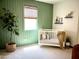 Calming Bedroom with stylish green accent wall, white crib, and neutral decor for a peaceful, modern aesthetic at 22443 E Munoz St, Queen Creek, AZ 85142