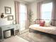 Bright bedroom featuring neutral carpet, pink patterned curtains and a metal bed frame with pink accents at 22443 E Munoz St, Queen Creek, AZ 85142
