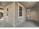 Cozy covered front porch features stucco and ample light, perfect for enjoying quiet moments outdoors at 22443 E Munoz St, Queen Creek, AZ 85142
