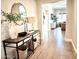 Hallway with wood flooring, decorative table and a glimpse into the bright living area at 22443 E Munoz St, Queen Creek, AZ 85142
