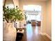Hallway with wood flooring, decorative table and a glimpse into the bright living area at 22443 E Munoz St, Queen Creek, AZ 85142