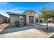 Inviting single-story home with a landscaped front yard, covered porch, and a two-car garage at 22443 E Munoz St, Queen Creek, AZ 85142