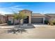 Welcoming single-story home with a two-car garage, desert landscaping, and a well-kept front yard at 22443 E Munoz St, Queen Creek, AZ 85142