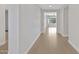 Bright hallway featuring wood floors, leading to the rest of the home's living spaces at 22443 E Munoz St, Queen Creek, AZ 85142