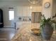 Elegant kitchen island featuring granite countertops, stainless steel appliances, and a modern aesthetic at 22443 E Munoz St, Queen Creek, AZ 85142