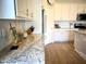 Close-up of the kitchen countertop, displaying granite countertops and white cabinetry with stainless steel appliances at 22443 E Munoz St, Queen Creek, AZ 85142