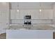 Bright kitchen features granite counters, stainless appliances, and stylish pendant lighting at 22443 E Munoz St, Queen Creek, AZ 85142