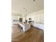 Spacious kitchen boasts an expansive island, white cabinetry, stainless steel appliances, and hardwood floors at 22443 E Munoz St, Queen Creek, AZ 85142