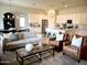 Open-concept living area featuring hardwood floors, stylish furnishings, and a seamless flow to the kitchen at 22443 E Munoz St, Queen Creek, AZ 85142