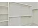 Bright walk-in closet with shelving and rods for optimal storage solutions in a modern home at 22443 E Munoz St, Queen Creek, AZ 85142