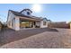 Backyard with covered patio, low maintenance landscape, and views of the exterior elevation at 2260 E Warbler Rd, Gilbert, AZ 85297
