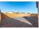 Low-maintenance backyard with gravel and surrounded by tall block wall at 2260 E Warbler Rd, Gilbert, AZ 85297