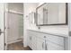 Bright bathroom with white cabinets, quartz countertop, brushed nickel faucet, and walk-in shower at 2260 E Warbler Rd, Gilbert, AZ 85297
