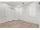 Bright bedroom featuring modern flooring and white plantation shutters for natural light at 2260 E Warbler Rd, Gilbert, AZ 85297