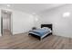 Clean bedroom featuring wood-look floors, recessed lighting, and bright windows at 2260 E Warbler Rd, Gilbert, AZ 85297