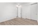 Light-filled bedroom with wood floors, white walls, a closet, and two doors at 2260 E Warbler Rd, Gilbert, AZ 85297