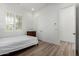 Bright bedroom featuring wood floors, white walls, shuttered windows, and recessed lighting at 2260 E Warbler Rd, Gilbert, AZ 85297