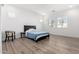 Bright bedroom with wood-look floors and large windows with plantation shutters at 2260 E Warbler Rd, Gilbert, AZ 85297