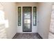 Close-up of an attractive front door with decorative glass inserts, and decorative side panels at 2260 E Warbler Rd, Gilbert, AZ 85297