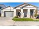 Single-story home with manicured lawn, paved driveway, and welcoming front entrance at 2260 E Warbler Rd, Gilbert, AZ 85297