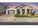 Beautiful single-story home with manicured lawn, columns, and a gray garage door at 2260 E Warbler Rd, Gilbert, AZ 85297